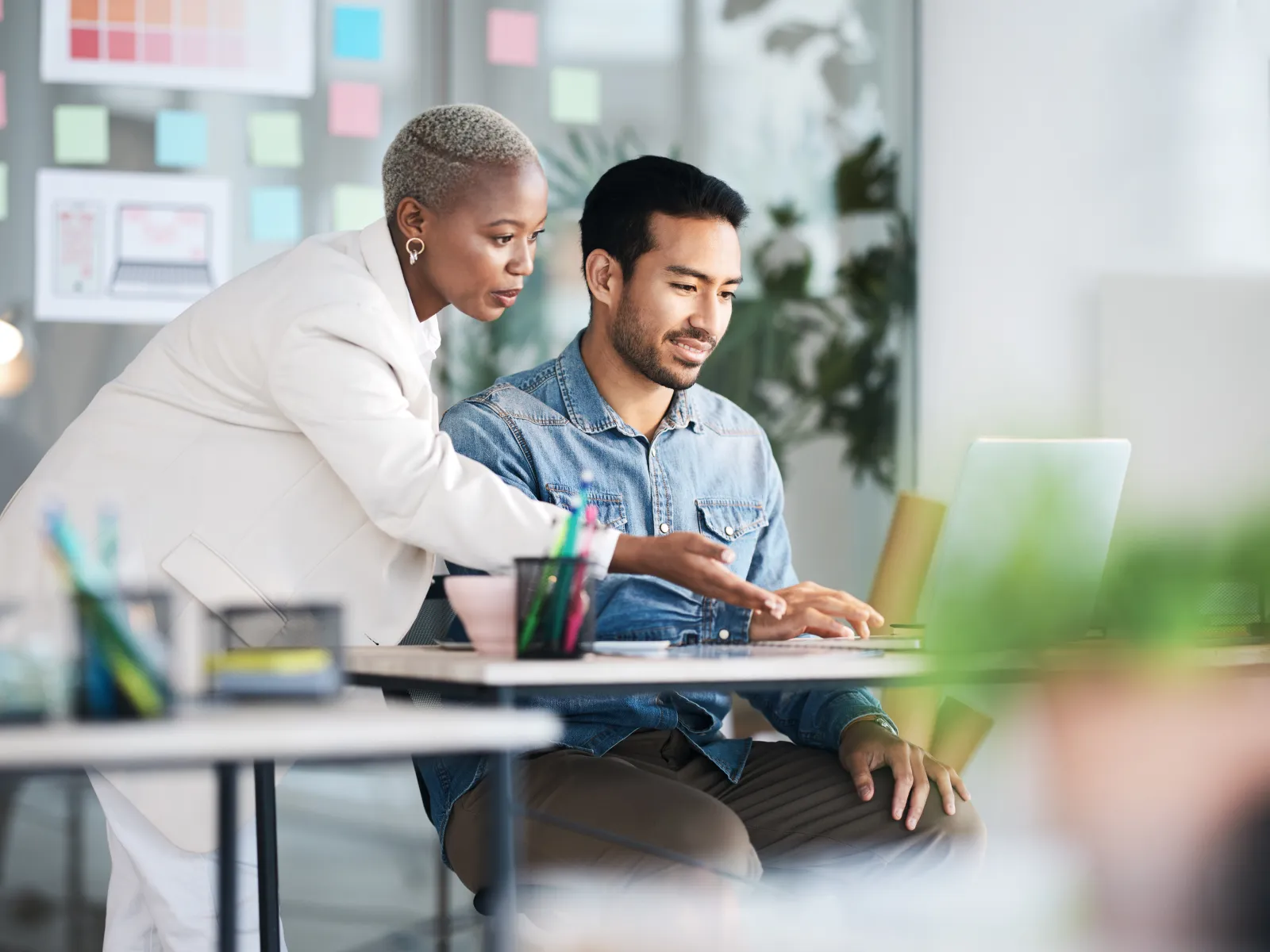 IT consultant reviewing managed IT support options on a laptop with a business client