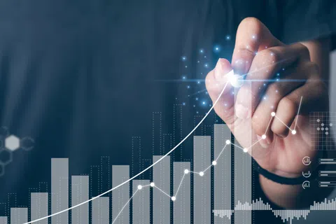 Hand drawing upward arrow on digital graph showing business growth and success trend