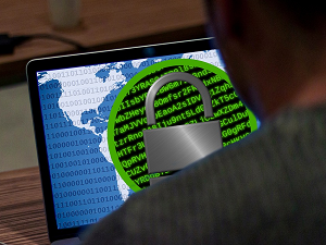 Padlock over binary code on a laptop screen, symbolizing hidden malware